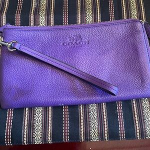 Vibrant Coach leather wristlet in purple